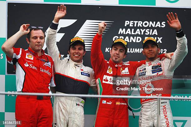 Ferrari Team Principal Stefano Domenicali, second placed Sergio Perez of Mexico and Sauber F1, race winner Fernando Alonso of Spain and Ferrari and...