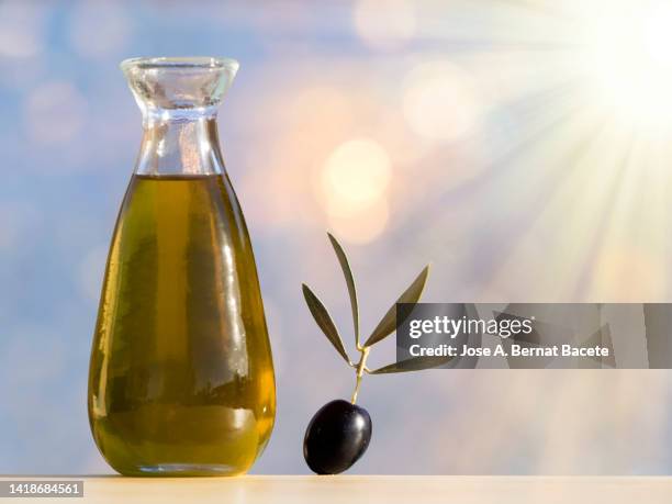 oil can with extra virgin olive oil illuminated by sunlight - wellness olive tree stock pictures, royalty-free photos & images