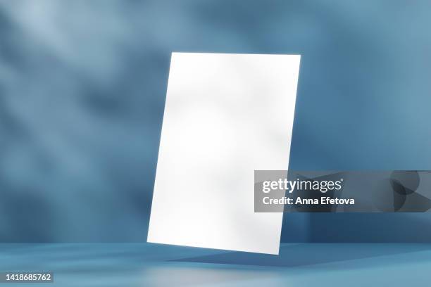 levitating white sheet a4 isolated on blue background with shadows. mockup for your design. three dimensional illustration - levitation stock pictures, royalty-free photos & images
