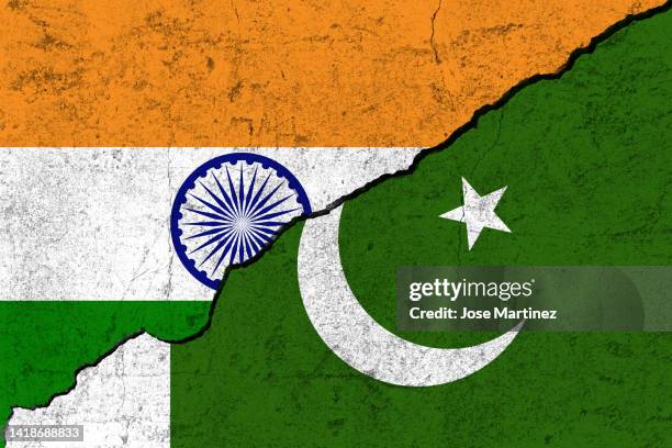 india vs pakistan flags divided by a crack, concept of war, wall texture, division between countries - indian democracy stock pictures, royalty-free photos & images