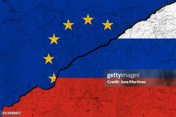 european union vs russia flags divided by a crack, concept of war and conflict - serbia eu stock pictures, royalty-free photos & images