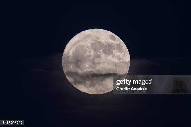 Full Moon rises over San Francisco Bay Area as fog blankets overall of Mount Tamalpais and Pacific Coast in Mill Valley, California, United States on...