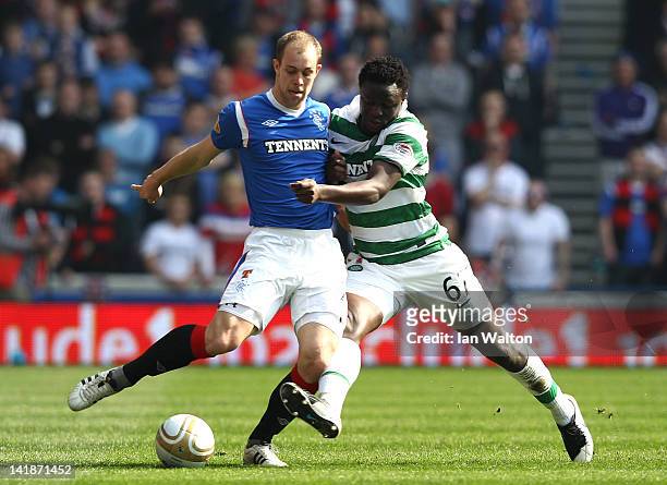 Yictor Wanyama of Celtic tries to tackle Steven Whittaker of Rangers during the Clydesdale Bank Scottish Premier League match between Rangers and...