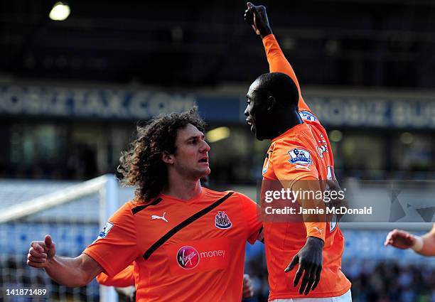 Papiss Cisse of Newcastle is congratulated by teammate Fabricio Coloccini of Newcastle after scoring the opening goal during the Barclays Premier...