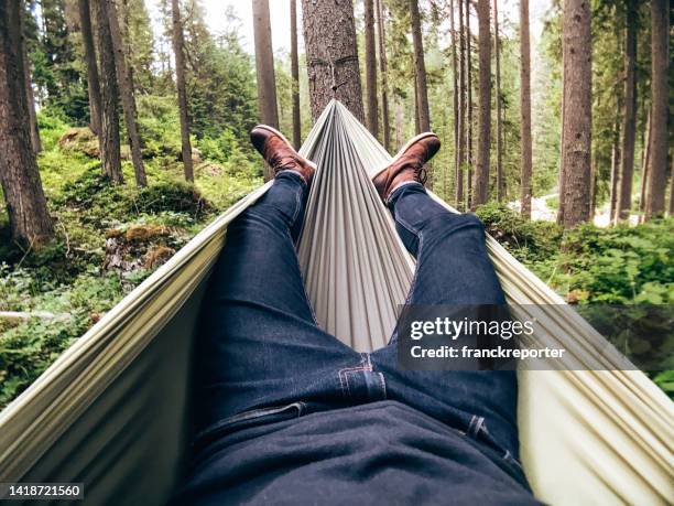 man resting on the hammock - bivouac stock pictures, royalty-free photos & images