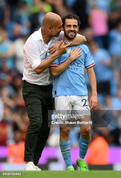 Bernardo Silva of Manchester City interacts with Pep Guardiola, Manager of Manchester City during the Premier League match between Manchester City...