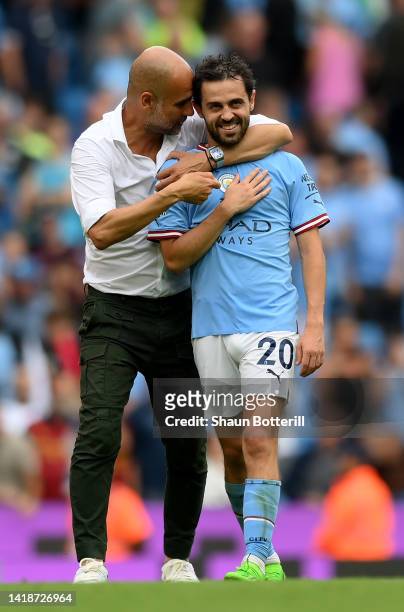 Bernardo Silva of Manchester City interacts with Pep Guardiola, Manager of Manchester City during the Premier League match between Manchester City...
