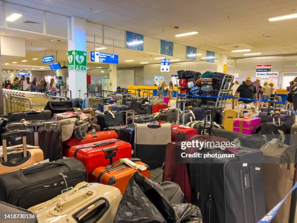 large pile of luggage at airport terminal - airport frustration stock pictures, royalty-free photos & images