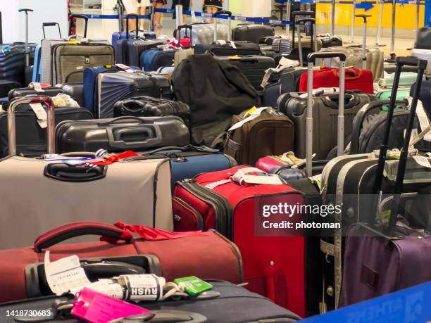 abandoned suitcases at airport terminal - airport frustration stock pictures, royalty-free photos & images