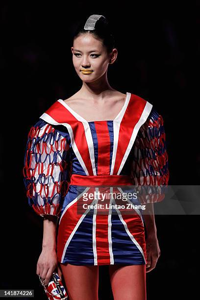 Model showcases designs on the catwalk during the Hempel award the 20th China intemational young fashion designers contest at Beijing hotel on March...