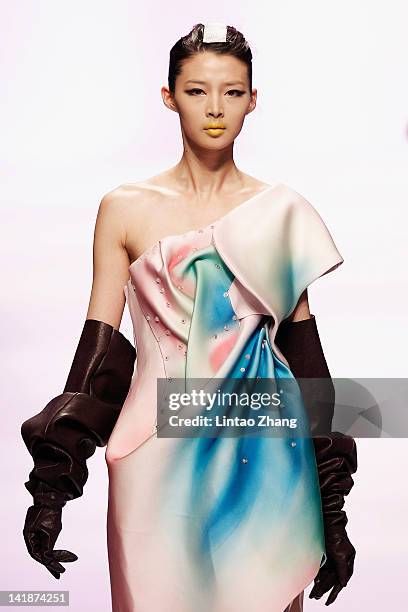 Model showcases designs on the catwalk during the Hempel award the 20th China intemational young fashion designers contest at Beijing hotel on March...