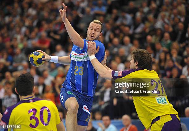 Pascal Hens of Hamburg is challenged by Ivan Nincevic and Alexander Pettersson of Berlin during the EHF Champions League match between HSV Hamburg...