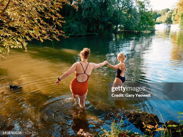 women river swimming - people swim river stockfoto's en -beelden