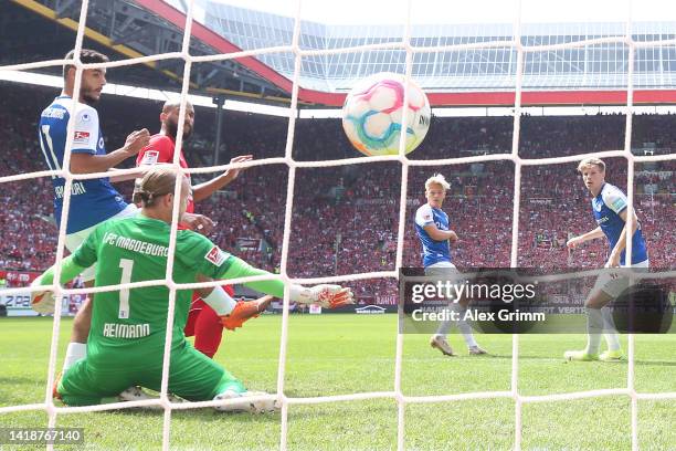 Terrence Boyd of Kaiserslautern scores their team's first goal past goalkeeper Dominik Reimann of 1. FC Magdeburg during the Second Bundesliga match...