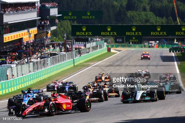 Carlos Sainz of Spain driving the Ferrari F1-75 leads the field into turn one at the start during the F1 Grand Prix of Belgium at Circuit de...