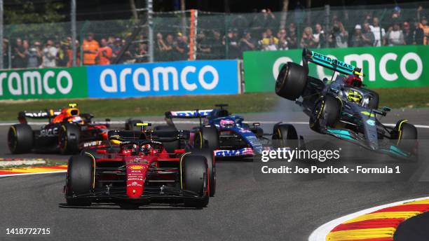 Carlos Sainz of Spain driving the Ferrari F1-75 leads the field as Fernando Alonso of Spain driving the Alpine F1 A522 Renault and Lewis Hamilton of...