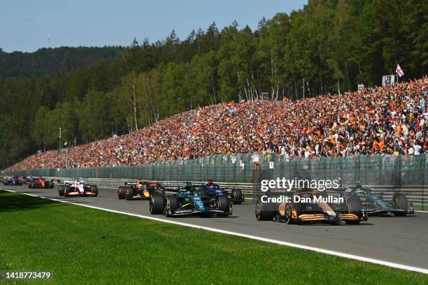 Daniel Ricciardo of Australia driving the McLaren MCL36 Mercedes leads Sebastian Vettel of Germany driving the Aston Martin AMR22 Mercedes Lance...