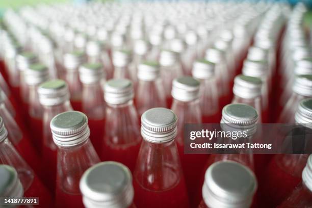 top view red juice, fruit mixed with basil seeds, clear bottle, flavored with pineapple flavor, ready to drink for health. - bottles glass top stockfoto's en -beelden