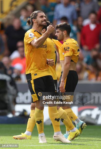 Ruben Neves of Wolverhampton Wanderers celebrates after scoring their team's first goal during the Premier League match between Wolverhampton...