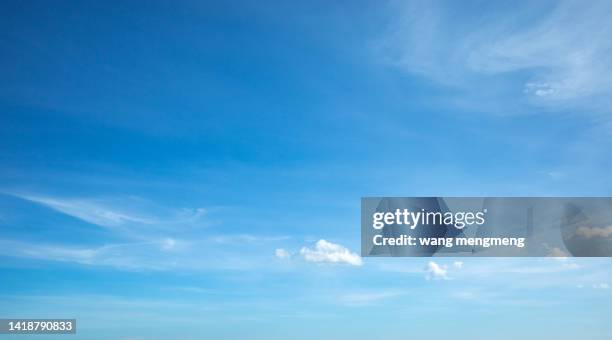 white clouds of different shapes in the blue sky - clouds fotografías e imágenes de stock