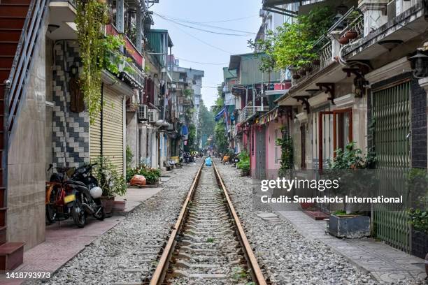 "hanoi train street", a railroad track in the middle of an old town street in hanoi, vietnam - hanoi cityscape stock pictures, royalty-free photos & images