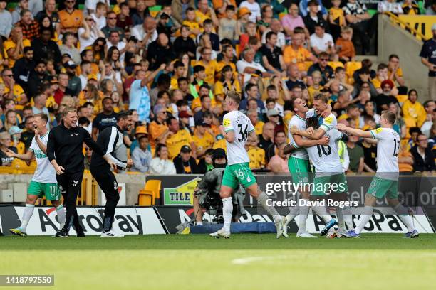 Allan Saint-Maximin of Newcastle United celebrates with team mates and manager, Eddie Howe after scoring their team's first goal during the Premier...