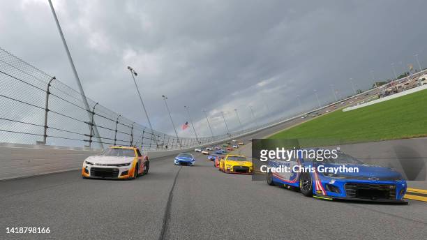 Kyle Larson, driver of the HendrickCars.com Chevrolet, and Chase Elliott, driver of the A SHOC Chevrolet, lead the field on a pace lap prior to the...