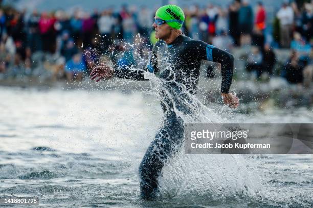 Athletes compete at the start of the swim portion during the IRONMAN Canada on August 28, 2022 in Penticton, British Columbia.