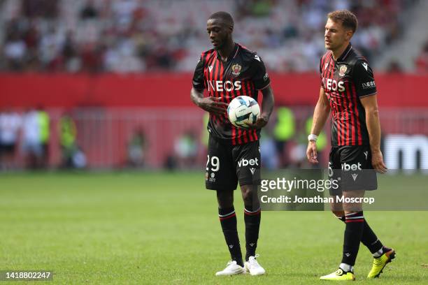 Nicolas Pepe and Aaron Ramsey of OGC Nice react as they preparec to take a free kick during the Ligue 1 match between OGC Nice and Olympique...