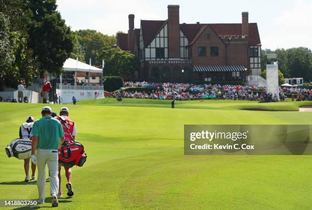 Scottie Scheffler of the United States walks on the 18th hole during the continuation of the weather delayed third round of the TOUR Championship at...