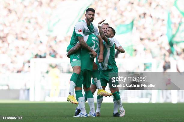 Anthony Jung of Werder Bremen celebrates with teammates after scoring their side's first goal during the Bundesliga match between SV Werder Bremen...