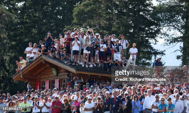 Spectators look on from a rooftop on the 18th hole during Day Four of the Omega European Masters at Crans-sur-Sierre Golf Club on August 28, 2022 in...