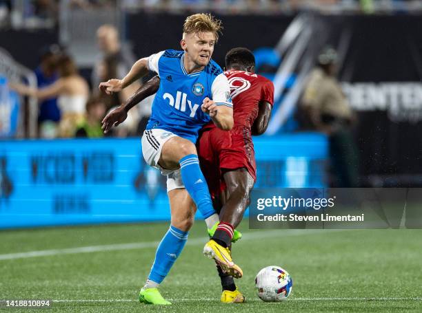 Kamil Jóźwiak of Charlotte FC and Richie Laryea of Toronto FC get tangled during a game between Toronto FC and Charlotte FC at Bank of America...