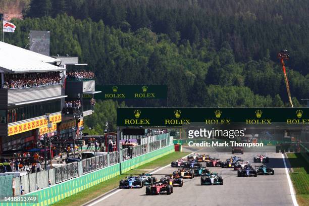 Carlos Sainz of Spain driving the Ferrari F1-75 leads the field at the start during the F1 Grand Prix of Belgium at Circuit de Spa-Francorchamps on...