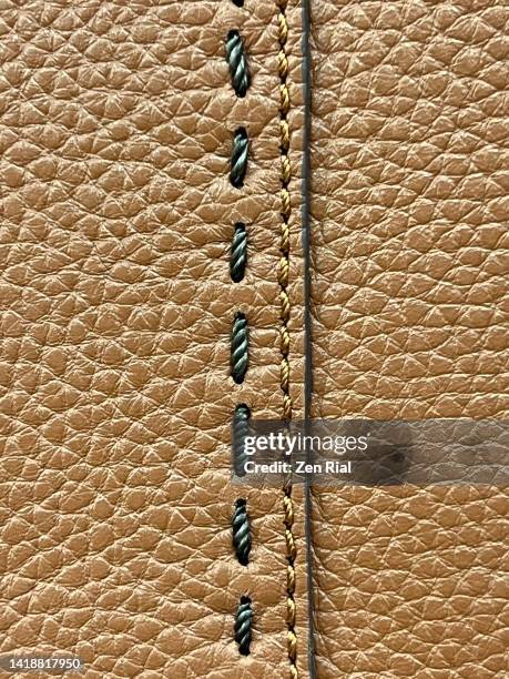 two types of machine stitches attaching two pieces of brown leather materials on a handbag - seam stock pictures, royalty-free photos & images