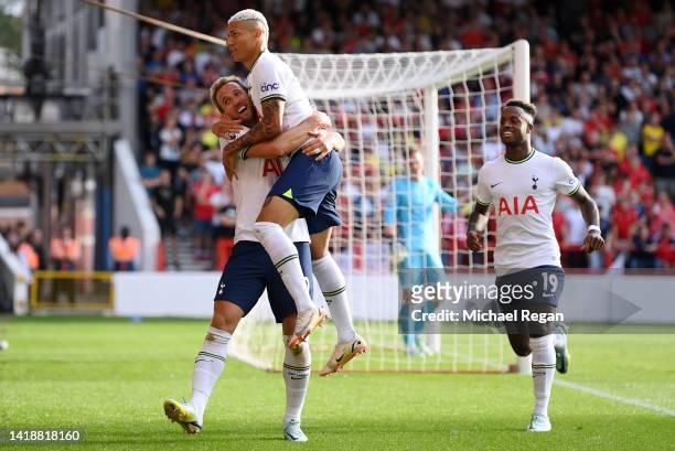 Harry Kane of Tottenham Hotspur celebrates with Richarlison after scoring their team's second goal during the Premier League match between Nottingham...