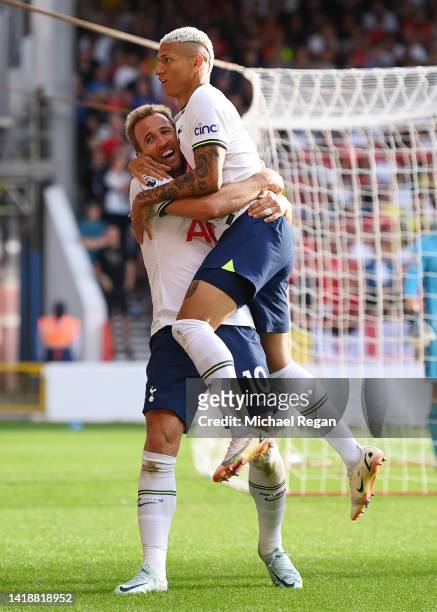 Harry Kane of Tottenham Hotspur celebrates with Richarlison after scoring their team's second goal during the Premier League match between Nottingham...