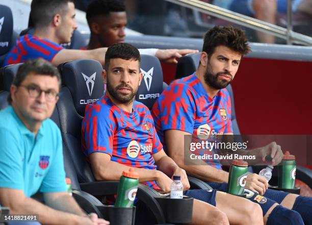 Jordi Alba and Gerard Pique of Barcelona look on from the substitutes bench prior to the LaLiga Santander match between FC Barcelona and Real...