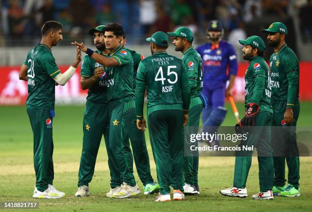 Naseem Shah of Pakistan celebrates with teammates after dismissing Suryakumar Yadav of India during the DP World Asia Cup T20 match between Pakistan...