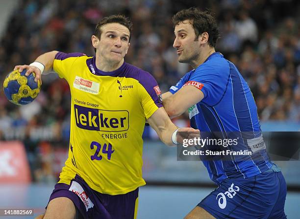 Bartlomiej Jaszka of Berlin is challenged by Marcin Lijewski of Hamburg during the EHF Champions League match between HSV Hamburg and Fuechse Berlin...