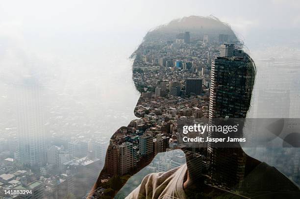 double exposure of man using phone and cityscape - young man asian silhouette stock pictures, royalty-free photos & images