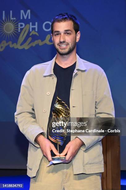 French director Leopold Legrand for "Le Sixieme Enfant " poses with his trophy after winning the Valois de la Musique award, the Valois du scenario...