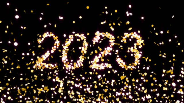 Text 2023 appearing from golden confetti explosion
