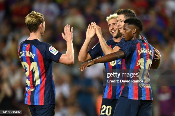 Sergi Roberto of Barcelona celebrates with teammates Frenkie de Jong, Robert Lewandowski and Ansu Fati after scoring their side's fourth goal during...