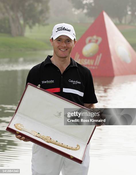 Michael Hoey of Northern Ireland with the winners trophy after the final round of the Trophee du Hassan II Golf at Golf du Palais Royal on March 25,...