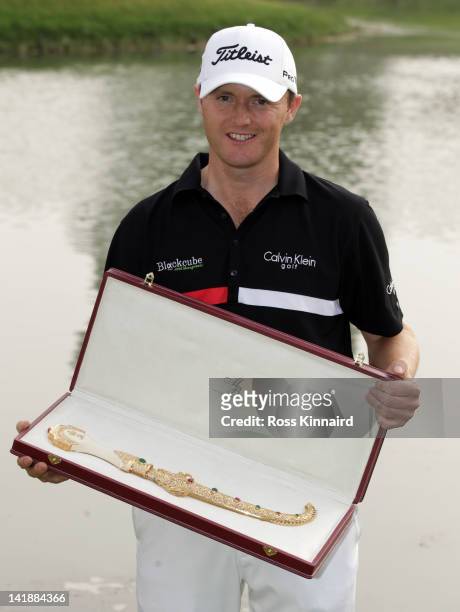 Michael Hoey of Northern Ireland with the winners trophy after the final round of the Trophee du Hassan II Golf at Golf du Palais Royal on March 25,...