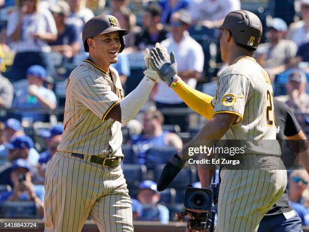 Manny Machado of the San Diego Padres celebrates his two-run home run with Juan Soto in the fifth inning against the Kansas City Royals at Kauffman...