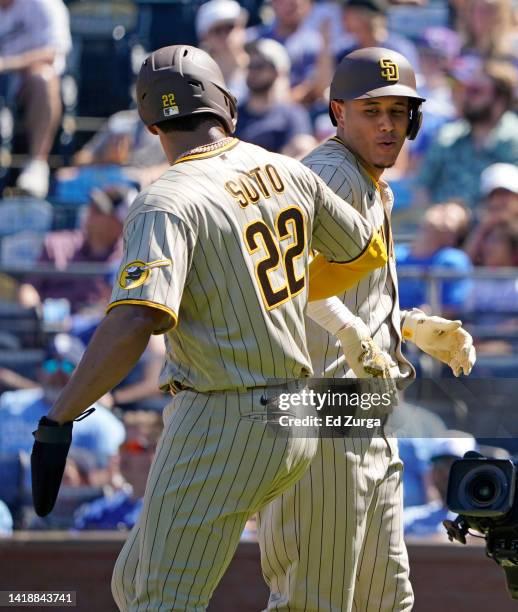 Manny Machado of the San Diego Padres celebrates his two-run home run with Juan Soto in the fifth inning against the Kansas City Royals at Kauffman...