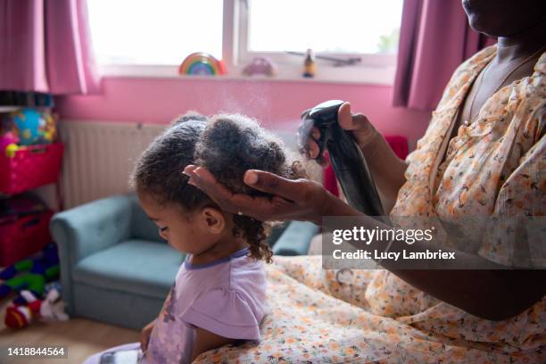 a mother is taking care of her daughter's hair - girls in wet dresses stock-fotos und bilder