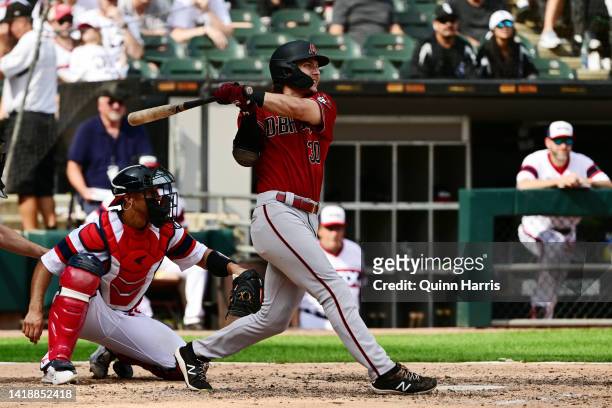 Jake McCarthy of the Arizona Diamondbacks hits an RBI double in the eighth inning against the Chicago White Sox at Guaranteed Rate Field on August...